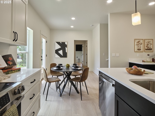 117 Witherbee Rd, Kelso, WA 98626 - kitchen with appliances with stainless steel finishes, light countertops, dark cabinetry, light wood-type flooring, and recessed lighting