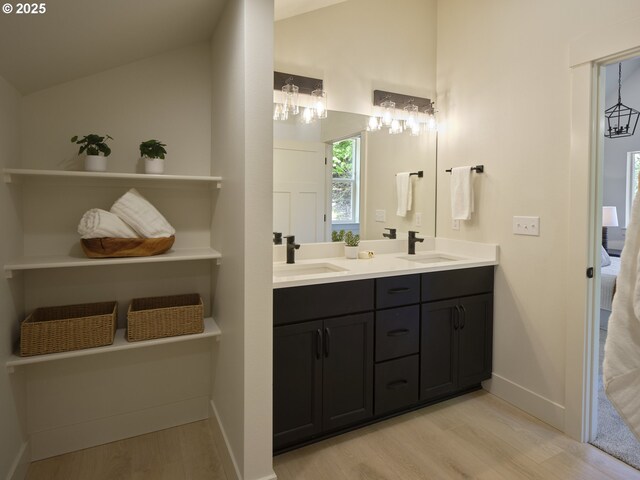 117 Witherbee Rd, Kelso, WA 98626 - bathroom featuring lofted ceiling, wood finished floors, double vanity, ensuite bath, and baseboards