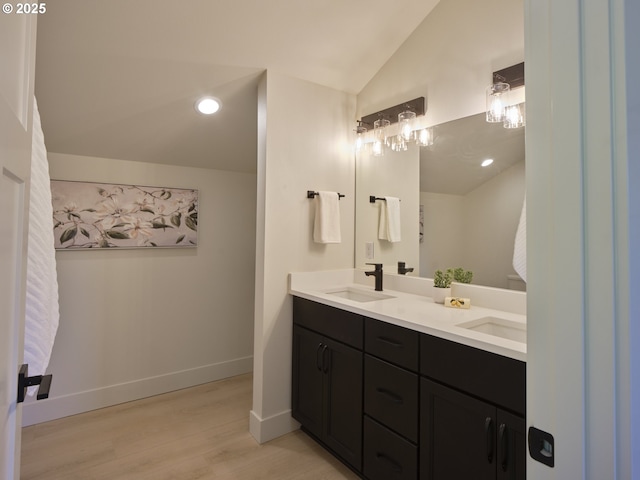117 Witherbee Rd, Kelso, WA 98626 - bathroom with double vanity, vaulted ceiling, wood finished floors, baseboards, and recessed lighting