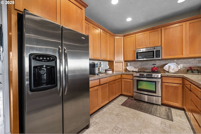 12 NW 17th Pl, Warrenton, OR 97146 - kitchen with appliances with stainless steel finishes, tasteful backsplash, recessed lighting, and brown cabinets