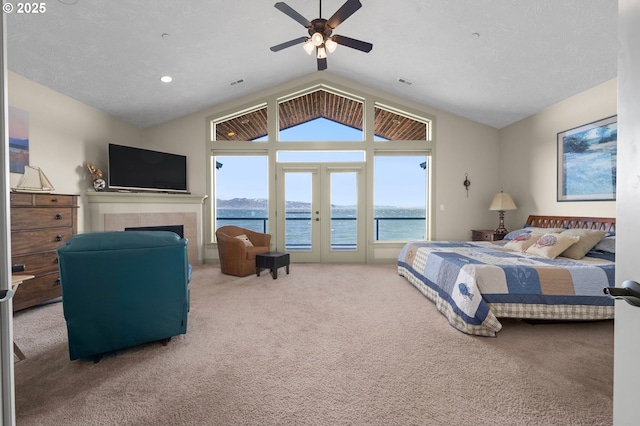 12 NW 17th Pl, Warrenton, OR 97146 - bedroom featuring vaulted ceiling, access to outside, carpet flooring, french doors, and a fireplace
