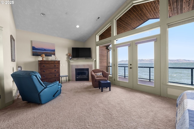 12 NW 17th Pl, Warrenton, OR 97146 - living area featuring vaulted ceiling, carpet floors, a fireplace, french doors, and recessed lighting