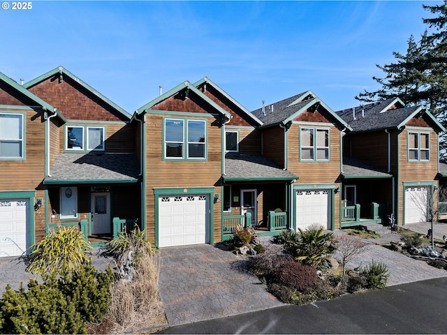 12 NW 17th Pl, Warrenton, OR 97146 - view of front of property with a garage, a porch, driveway, and roof with shingles