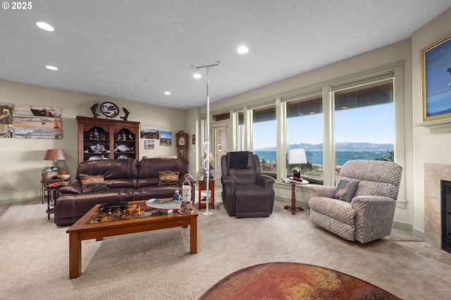 12 NW 17th Pl, Warrenton, OR 97146 - living room featuring carpet flooring, a tile fireplace, recessed lighting, and a textured ceiling