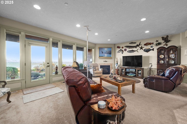 12 NW 17th Pl, Warrenton, OR 97146 - living room with carpet flooring, recessed lighting, a textured ceiling, and a fireplace