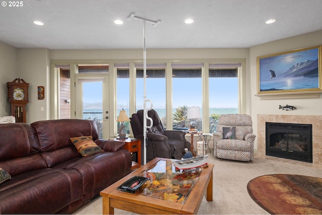 12 NW 17th Pl, Warrenton, OR 97146 - living area featuring light carpet, recessed lighting, a tile fireplace, and french doors