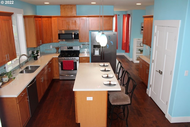 2917 SW 198th Ave, Beaverton, OR 97003 - kitchen featuring stainless steel appliances, a center island, a kitchen bar, light countertops, and tasteful backsplash