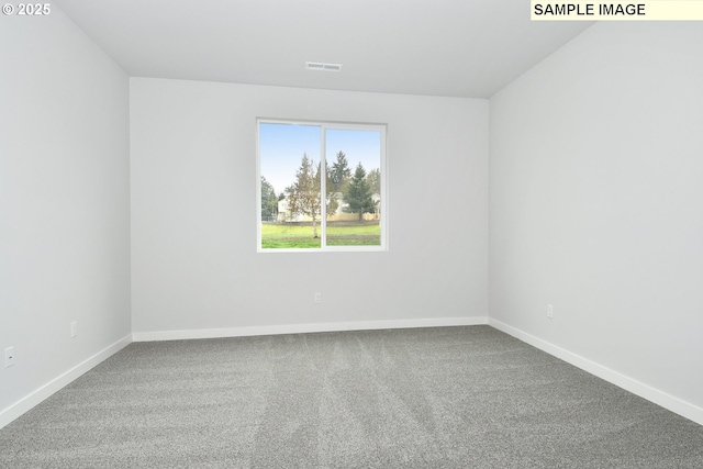 spare room featuring visible vents, carpet flooring, and baseboards