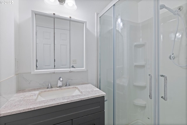 full bathroom with vanity and a stall shower