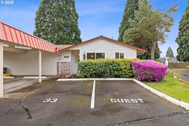 view of front of property with uncovered parking and brick siding