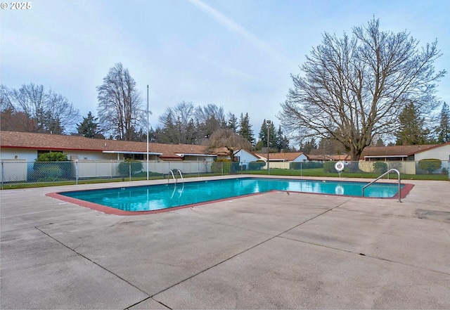 pool featuring a patio area and fence