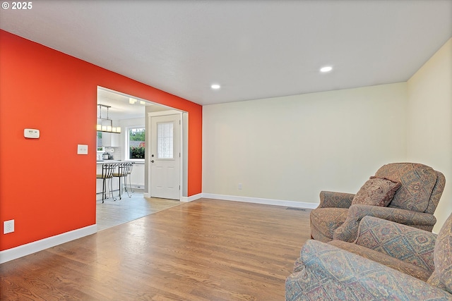 sitting room featuring baseboards, recessed lighting, wood finished floors, and visible vents