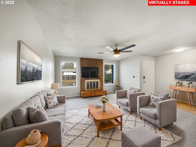 living room featuring a textured ceiling and ceiling fan