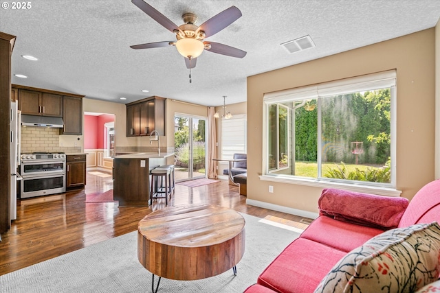 702 SW Burlingame Cir, Troutdale, OR 97060 - living room with dark wood finished floors, ceiling fan, and a textured ceiling