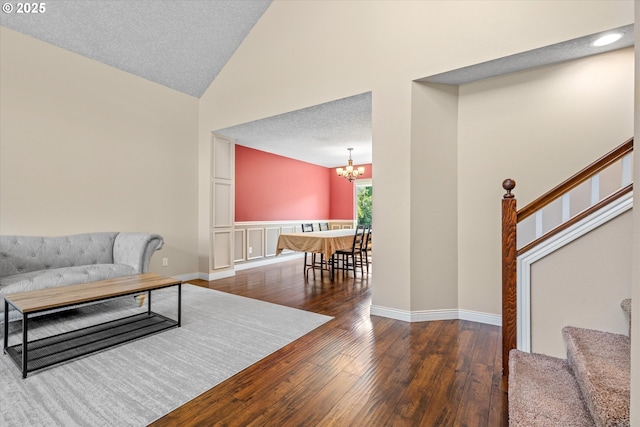 702 SW Burlingame Cir, Troutdale, OR 97060 - living area with wood-type flooring, high vaulted ceiling, stairs, and a chandelier