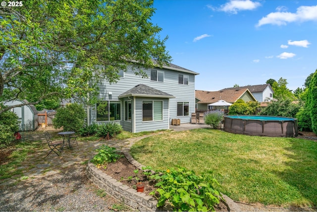 702 SW Burlingame Cir, Troutdale, OR 97060 - rear view of house featuring a storage shed, a fenced backyard, a patio area, an outdoor pool, and roof with shingles