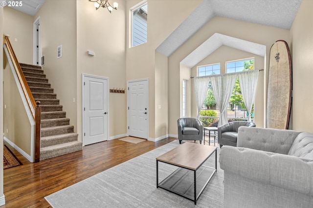 702 SW Burlingame Cir, Troutdale, OR 97060 - living room with wood finished floors, stairs, and high vaulted ceiling
