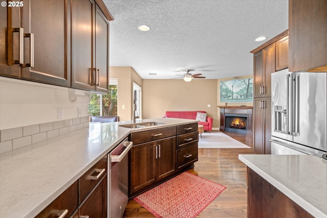 702 SW Burlingame Cir, Troutdale, OR 97060 - kitchen featuring stainless steel appliances, healthy amount of natural light, open floor plan, a ceiling fan, and a textured ceiling
