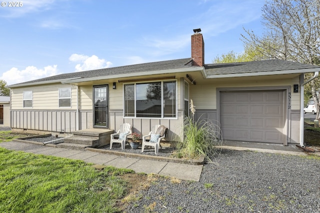 53112 NW Manor Dr, Scappoose, OR 97056 - ranch-style home featuring roof with shingles, driveway, a garage, and a chimney
