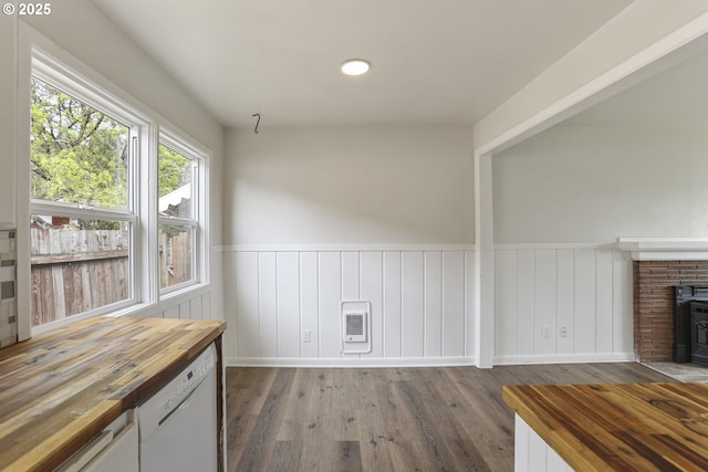 53112 NW Manor Dr, Scappoose, OR 97056 - unfurnished living room with a wood stove, heating unit, wainscoting, and wood finished floors
