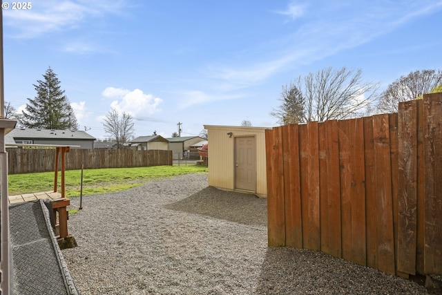 53112 NW Manor Dr, Scappoose, OR 97056 - view of yard featuring a fenced backyard, an outdoor structure, and a storage unit