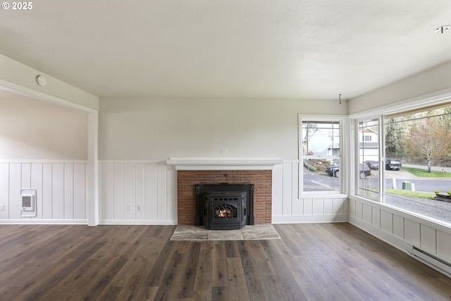 53112 NW Manor Dr, Scappoose, OR 97056 - unfurnished living room featuring a baseboard radiator, wood finished floors, wainscoting, and heating unit