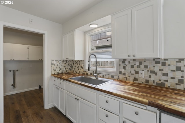 53112 NW Manor Dr, Scappoose, OR 97056 - kitchen with tasteful backsplash, a sink, dark wood-style floors, butcher block counters, and white cabinetry
