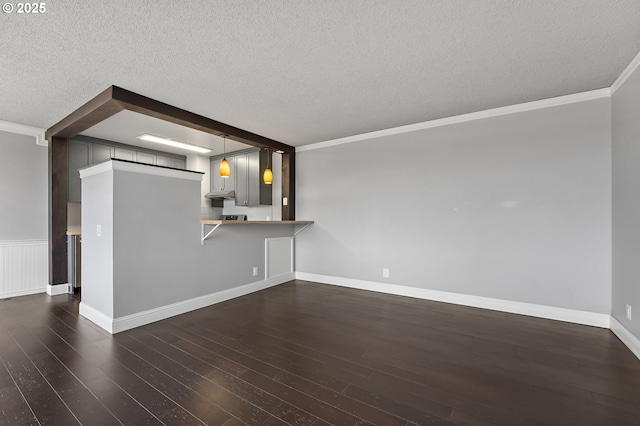 1220 NE 17th Ave Unit 12B, Portland, OR 97232 - unfurnished living room with a textured ceiling, ornamental molding, and hardwood / wood-style floors