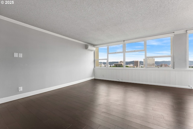 1220 NE 17th Ave Unit 12B, Portland, OR 97232 - unfurnished room featuring a textured ceiling, dark wood-style flooring, and ornamental molding