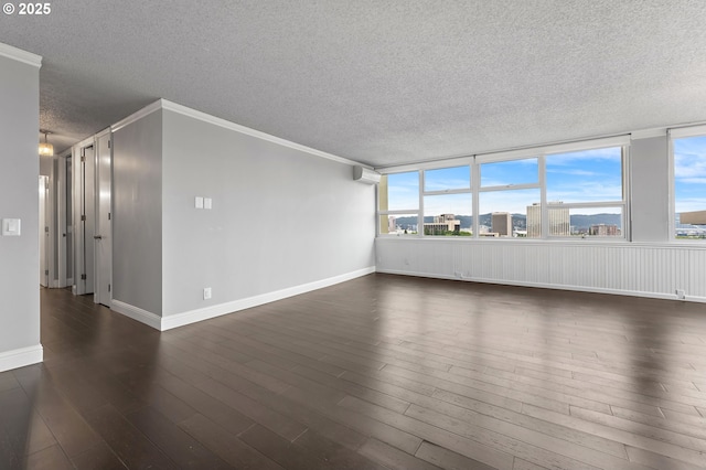 1220 NE 17th Ave Unit 12B, Portland, OR 97232 - unfurnished room with a textured ceiling, dark wood finished floors, and crown molding