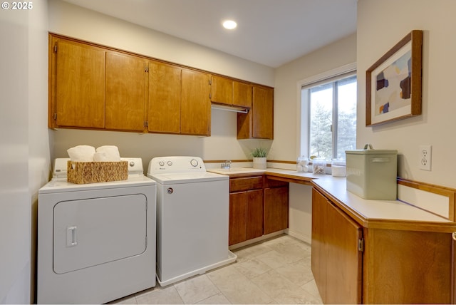 laundry room featuring cabinets, sink, and washer and dryer