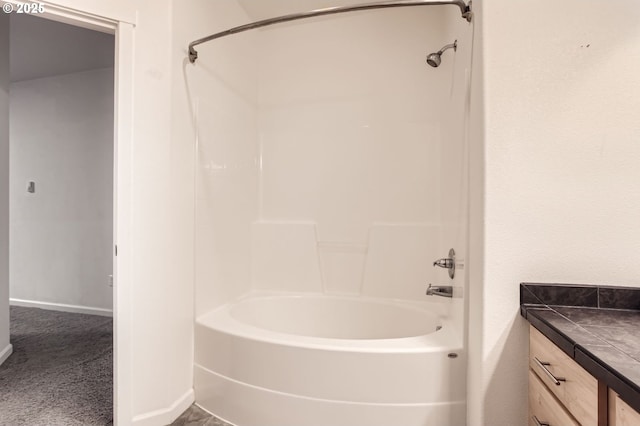 bathroom with vanity, baseboards, and washtub / shower combination