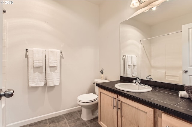 full bathroom with a shower, vanity, baseboards, and toilet