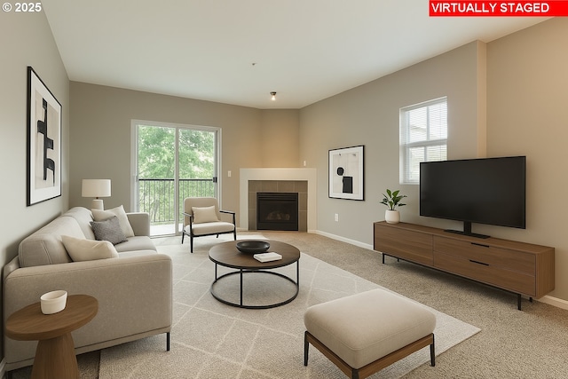 carpeted living room with baseboards, plenty of natural light, and a fireplace