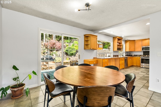 6750 SW Parkwest Ln, Portland, OR 97225 - dining space with a textured ceiling, light tile patterned floors, baseboards, and recessed lighting