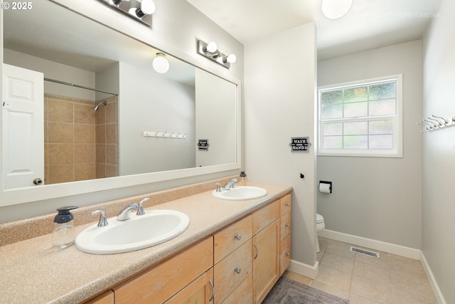 6750 SW Parkwest Ln, Portland, OR 97225 - full bathroom with double vanity, tile patterned floors, toilet, baseboards, and a shower