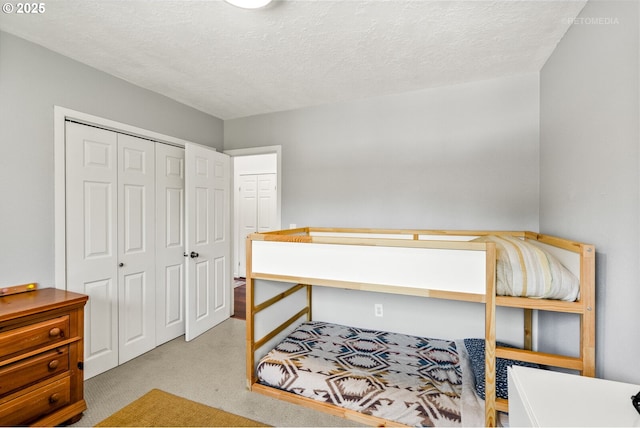 6750 SW Parkwest Ln, Portland, OR 97225 - carpeted bedroom with a closet and a textured ceiling