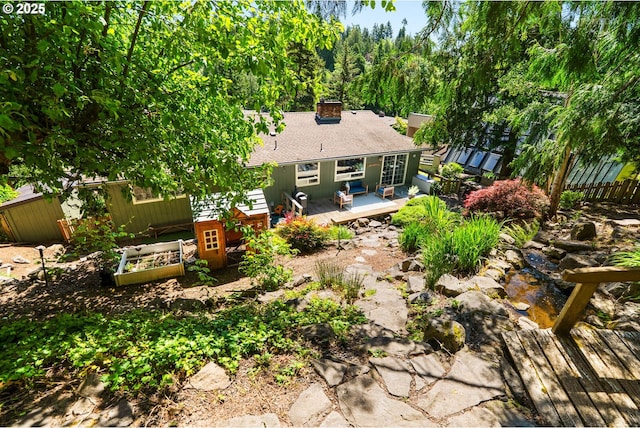 6750 SW Parkwest Ln, Portland, OR 97225 - rear view of house with a deck, a chimney, and a shingled roof