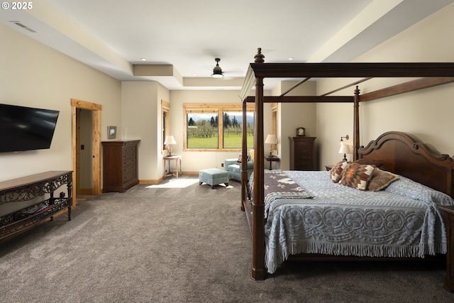 carpeted bedroom featuring baseboards, recessed lighting, a raised ceiling, and visible vents