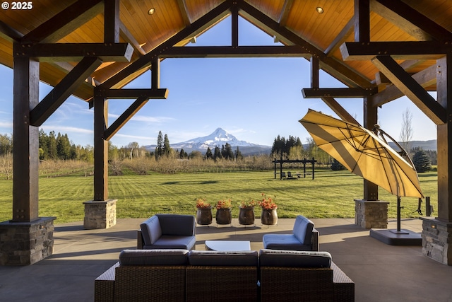 view of patio / terrace featuring an outdoor hangout area, a mountain view, a gazebo, and a rural view