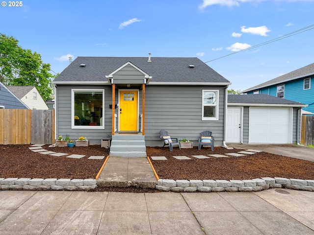 121 NE Edison St, Hillsboro, OR 97124 - view of front of home with fence, concrete driveway, roof with shingles, and an outbuilding