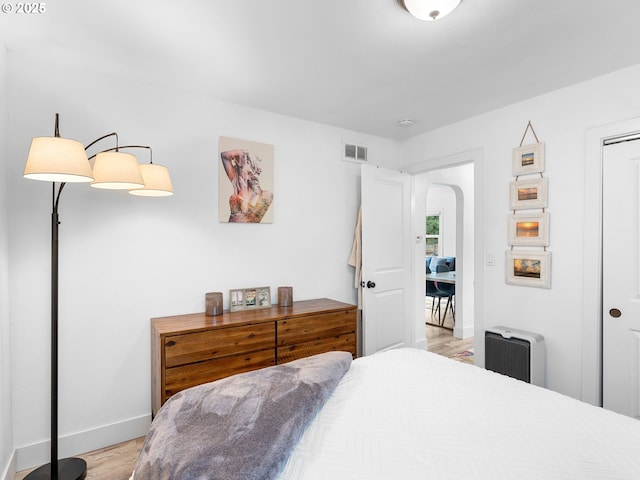 121 NE Edison St, Hillsboro, OR 97124 - bedroom with baseboards, light wood-style floors, arched walkways, and a closet