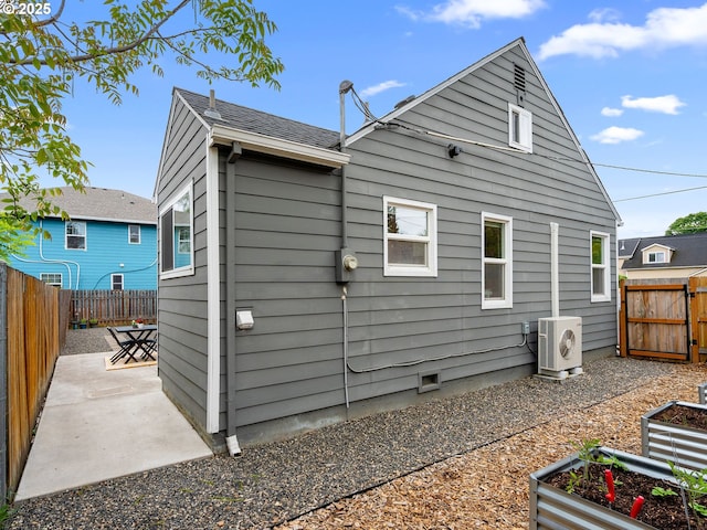 121 NE Edison St, Hillsboro, OR 97124 - back of property with ac unit, a patio, a fenced backyard, and a garden