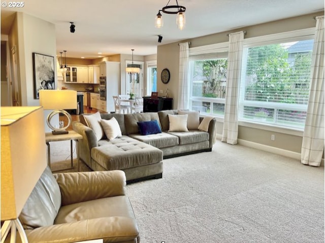 carpeted living room featuring baseboards