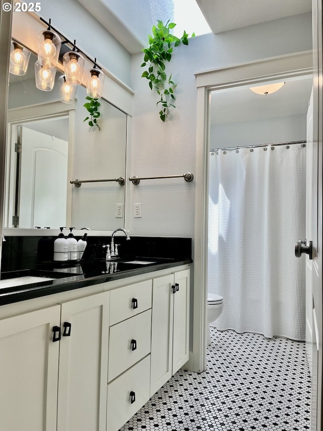 bathroom with vanity, toilet, and a shower with shower curtain