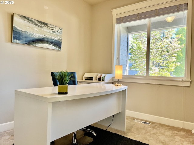carpeted home office featuring baseboards