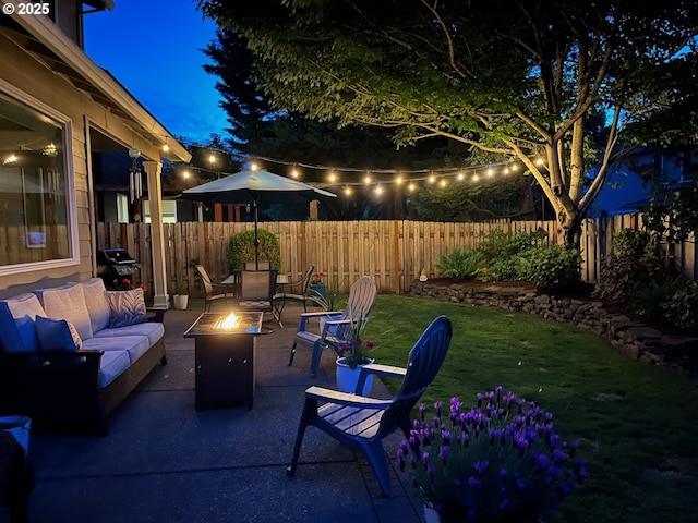 patio at twilight featuring an outdoor living space with a fire pit and a grill