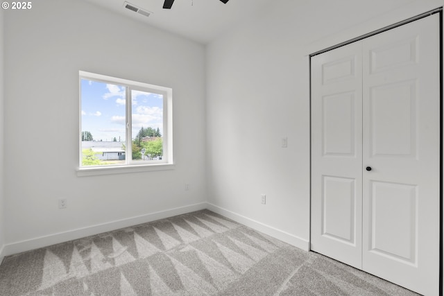 413 S Trade St, Amity, OR 97101 - unfurnished bedroom featuring light carpet, baseboards, a closet, and a ceiling fan