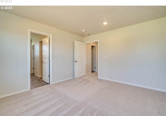 unfurnished bedroom with light colored carpet