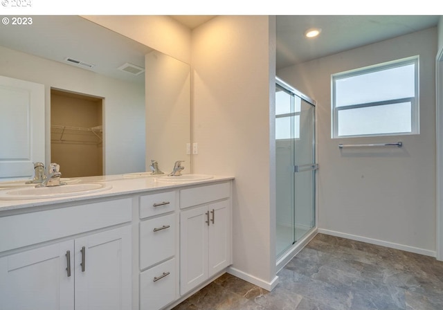 bathroom with vanity and a shower with shower door